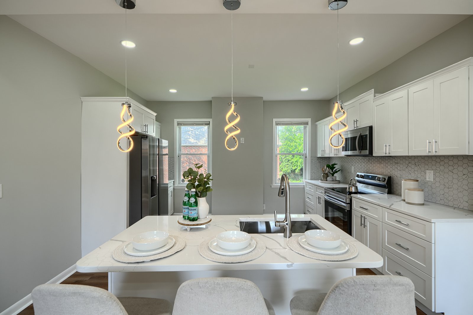 Kitchen island with quartz countertop and spiral pendant lights