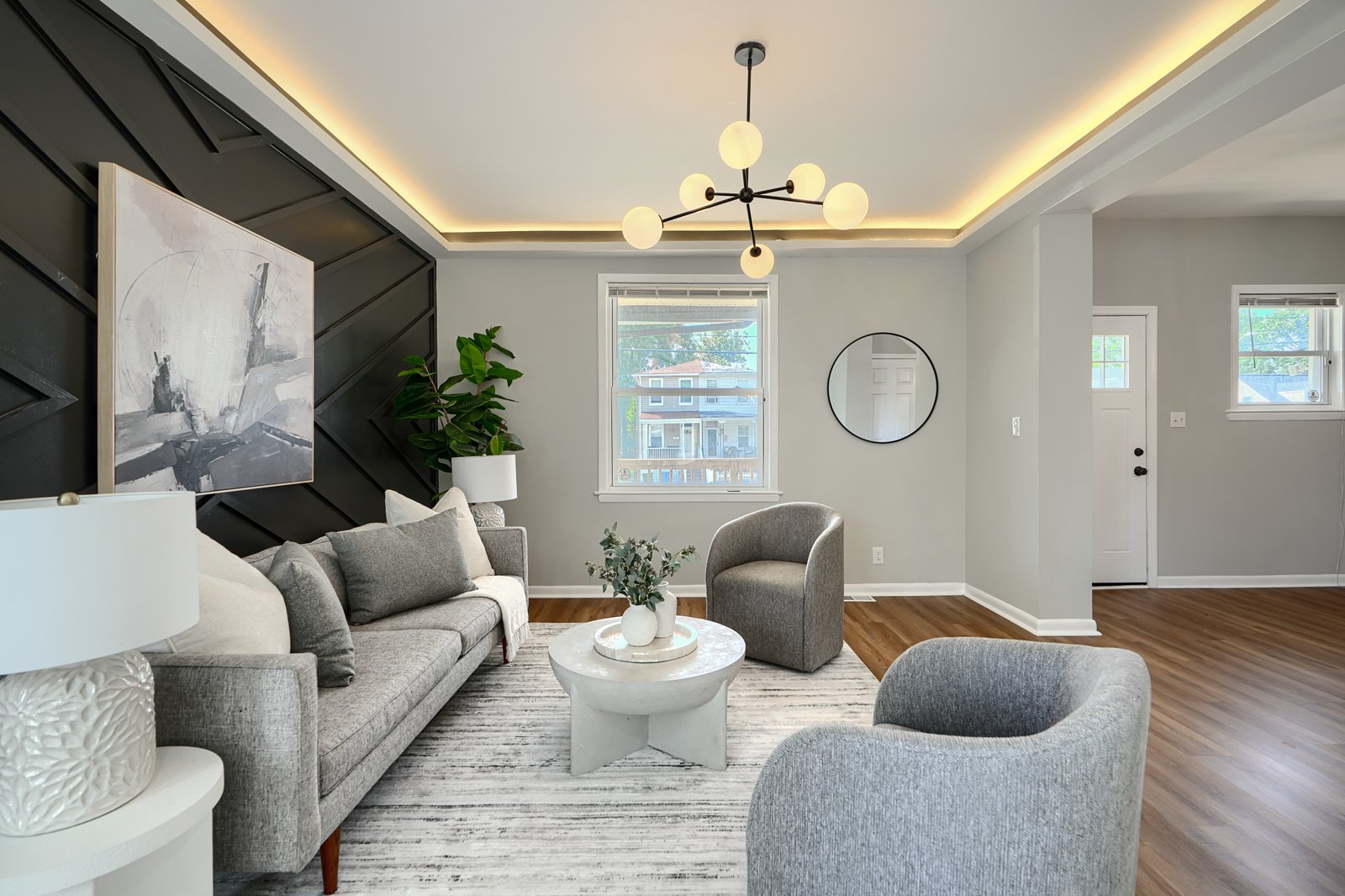 Living room with dark chevron accent wall and cove lighting