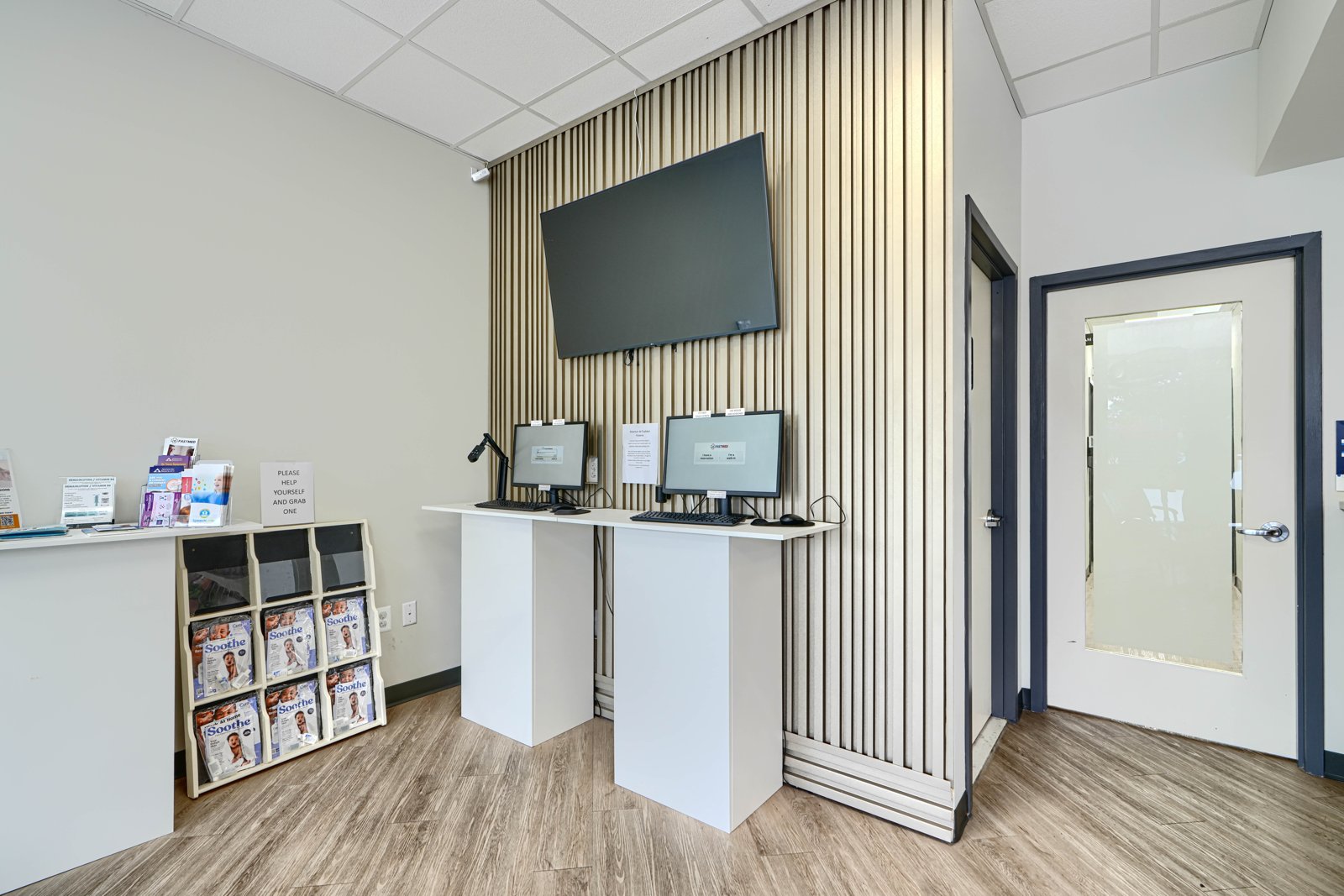Patient check-in kiosks with slatted wood accent wall