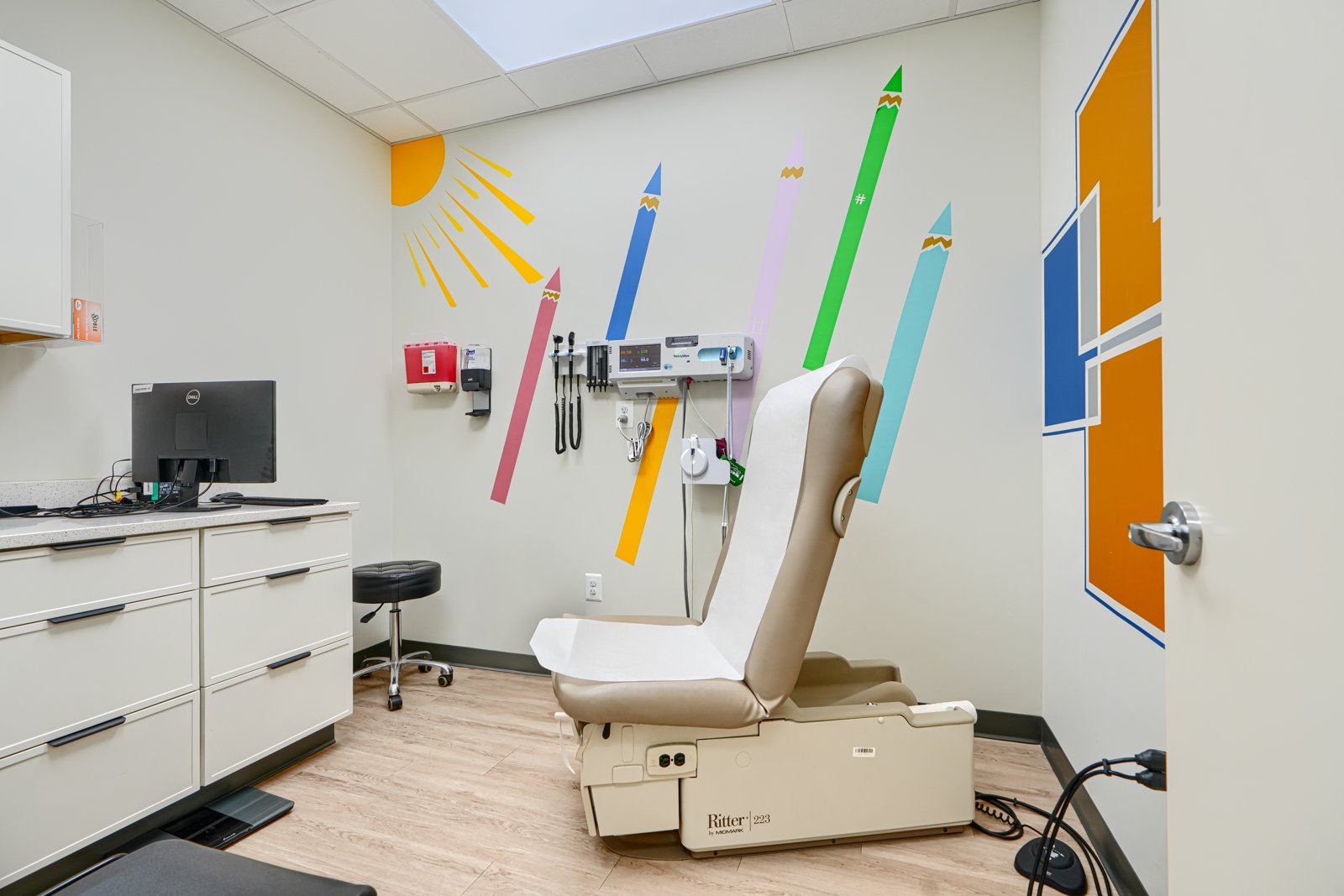 Pediatric exam room with colorful crayon wall mural