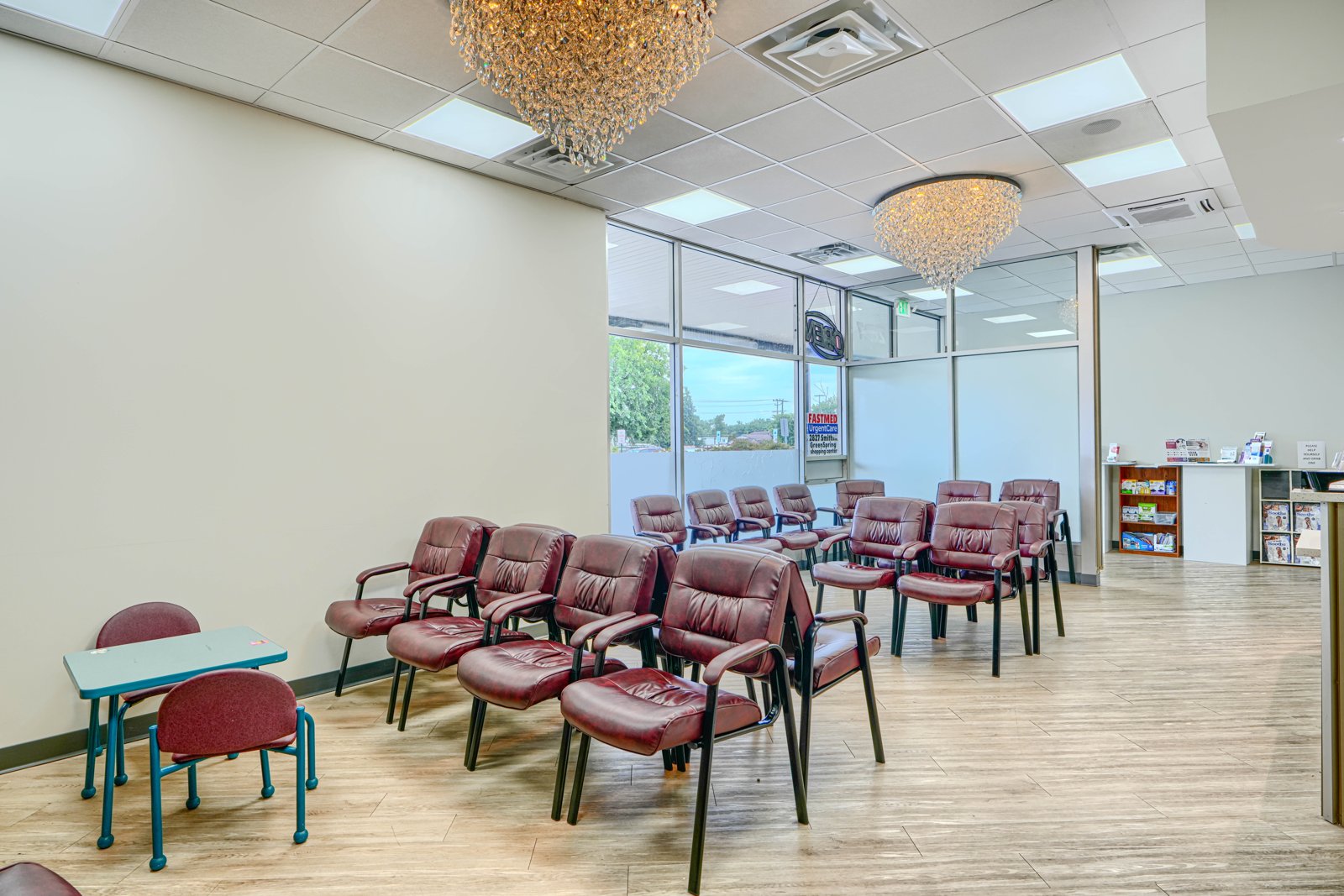Spacious waiting room with crystal chandeliers and children's play area